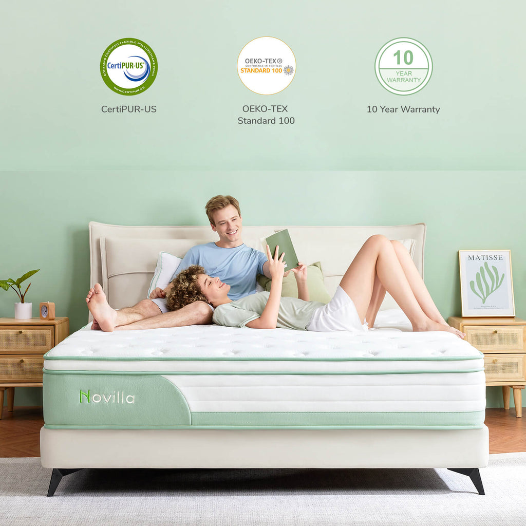 A couple reads a book on a white and green Novilla mattress. CertiPUR-US, OEKO-TEX, and 10 Year Warranty logos are displayed