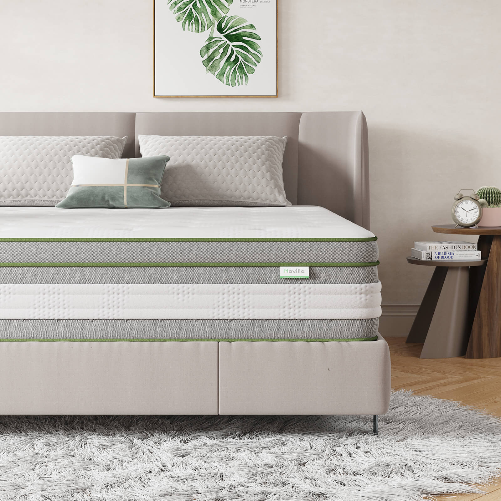 Novilla Vitality 12-inch hybrid mattress with green trim and grey textured sides on a beige bed frame with pillows.