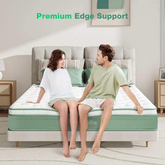 Oasis Hybrid Mattress: Couple testing premium edge support. White quilted top, green sides, Novilla logo.