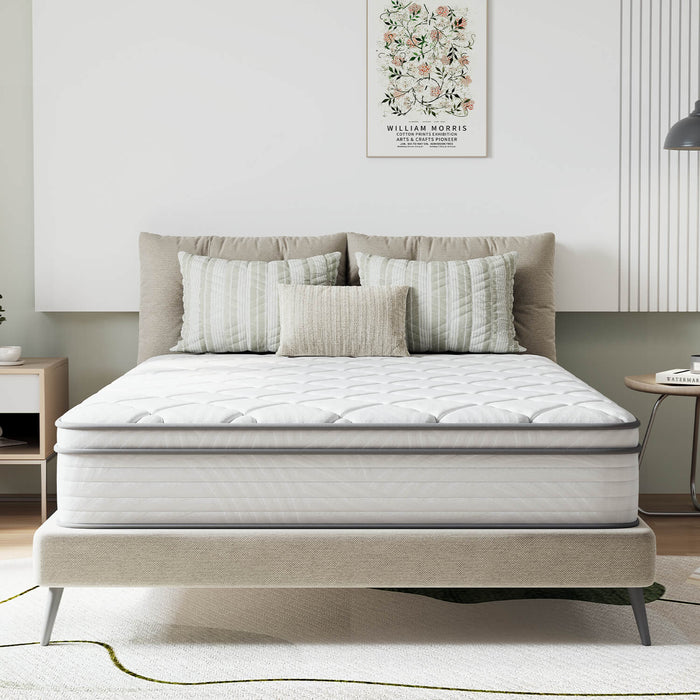 AirBreeze Hybrid Mattress on upholstered bed frame with quilted top and grey piping.